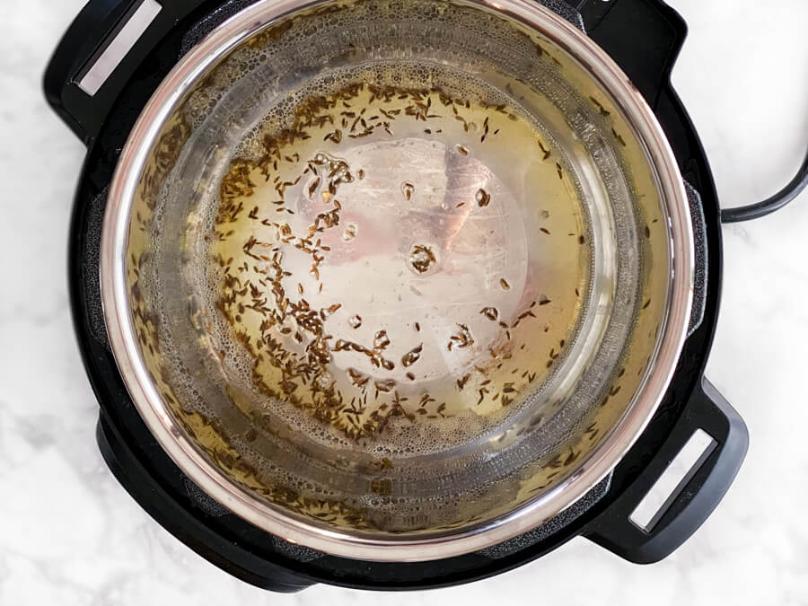 cumin seeds cooking in oil
