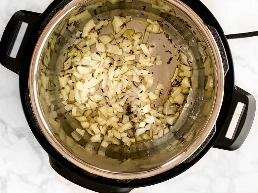 onion and cumin cooking in oil