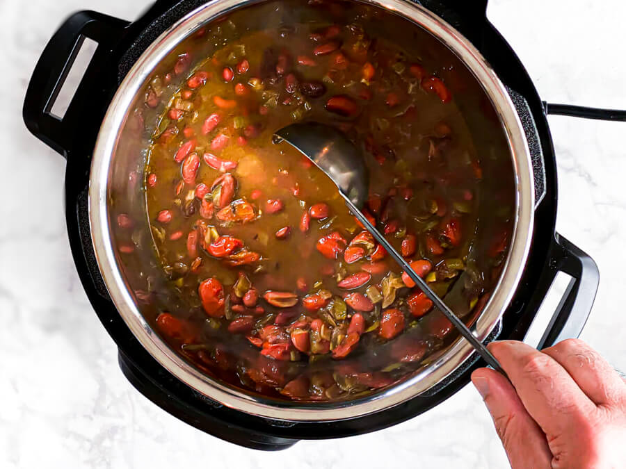 hand stirring cooked rajma