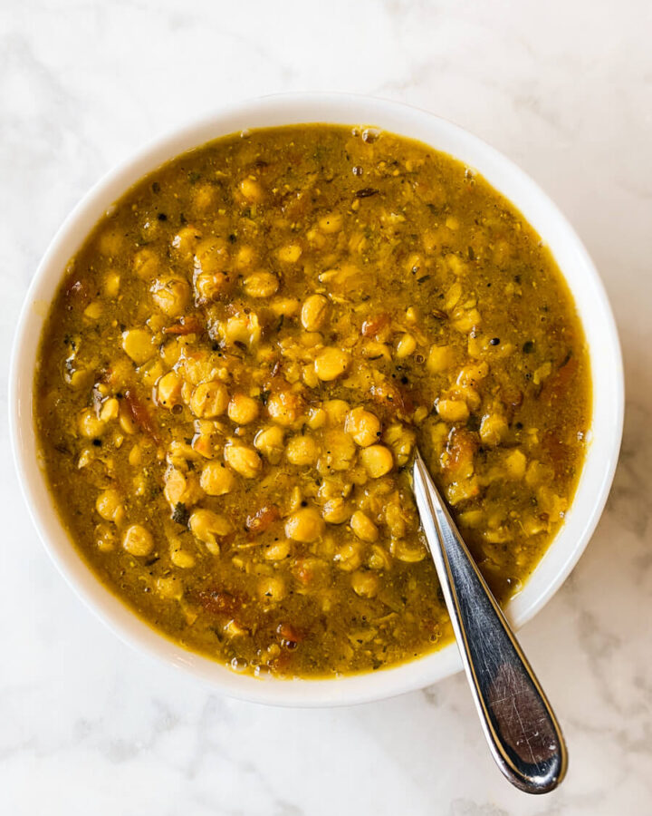 Bowl of chana dal with a spoon in it.