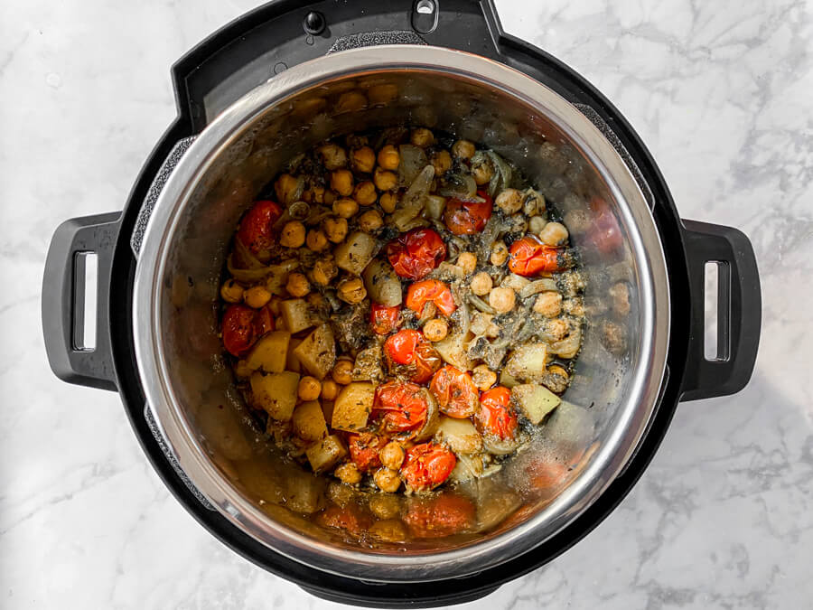 Pressure cooker with cooked chana masala.